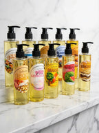 Assorted bottles of soap with pump dispensers on a marble surface