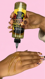Woman pouring body oil onto her hand with colorful nail art, pink background