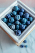 Realistic blueberry wax melts in a ceramic warmer, dessert-inspired home fragrance