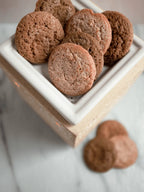 Ginger snap wax melts shaped like cookies in a white ceramic warmer