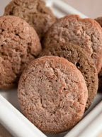 Close-up of ginger snap wax melts with a textured, cookie-like appearance on a white tray