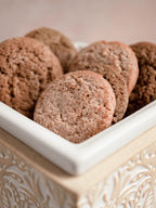 Ginger snap wax melts arranged in a decorative cream-colored ceramic dish