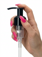 Hand holding black lotion pump dispenser with pink manicured nails on white background
